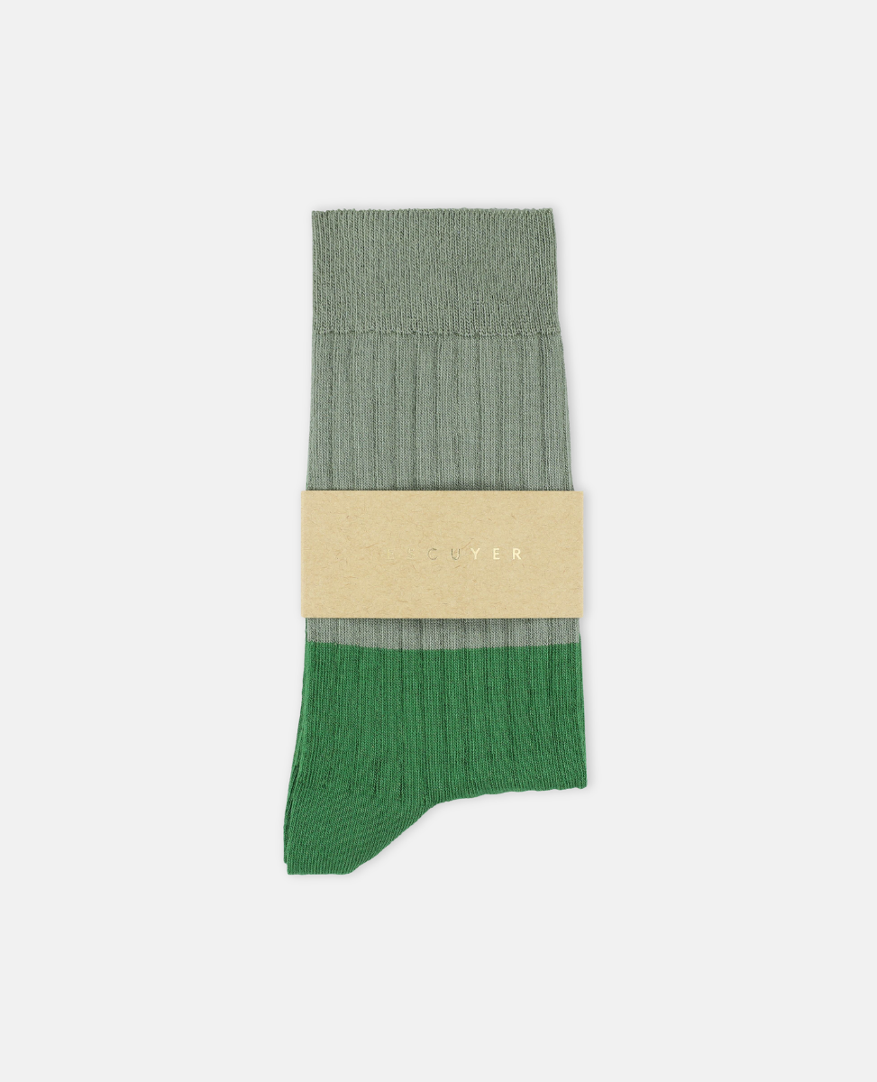 Escuyer Green sock with beige label on a white background