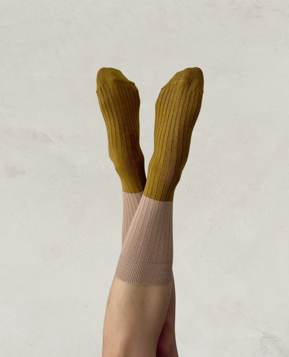 Escuyer Green knee-high socks with a beige gradient on a light background