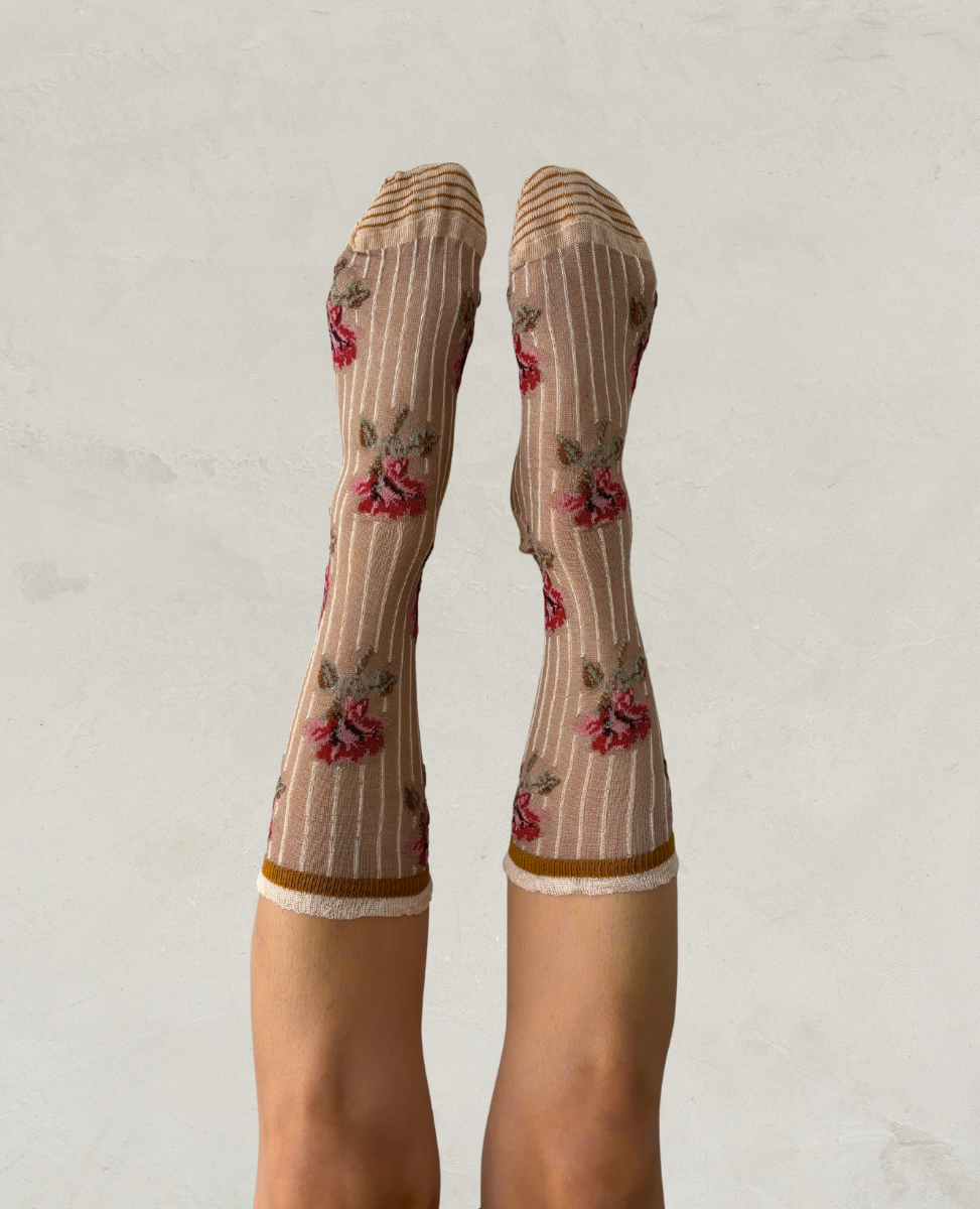 Exquisite J socks with floral and stripe design on a plain background