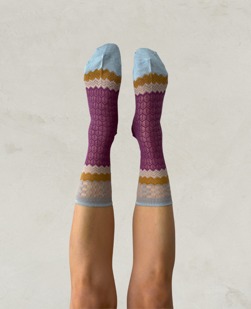 Exquisite J Purple socks with colorful patterns on a neutral background