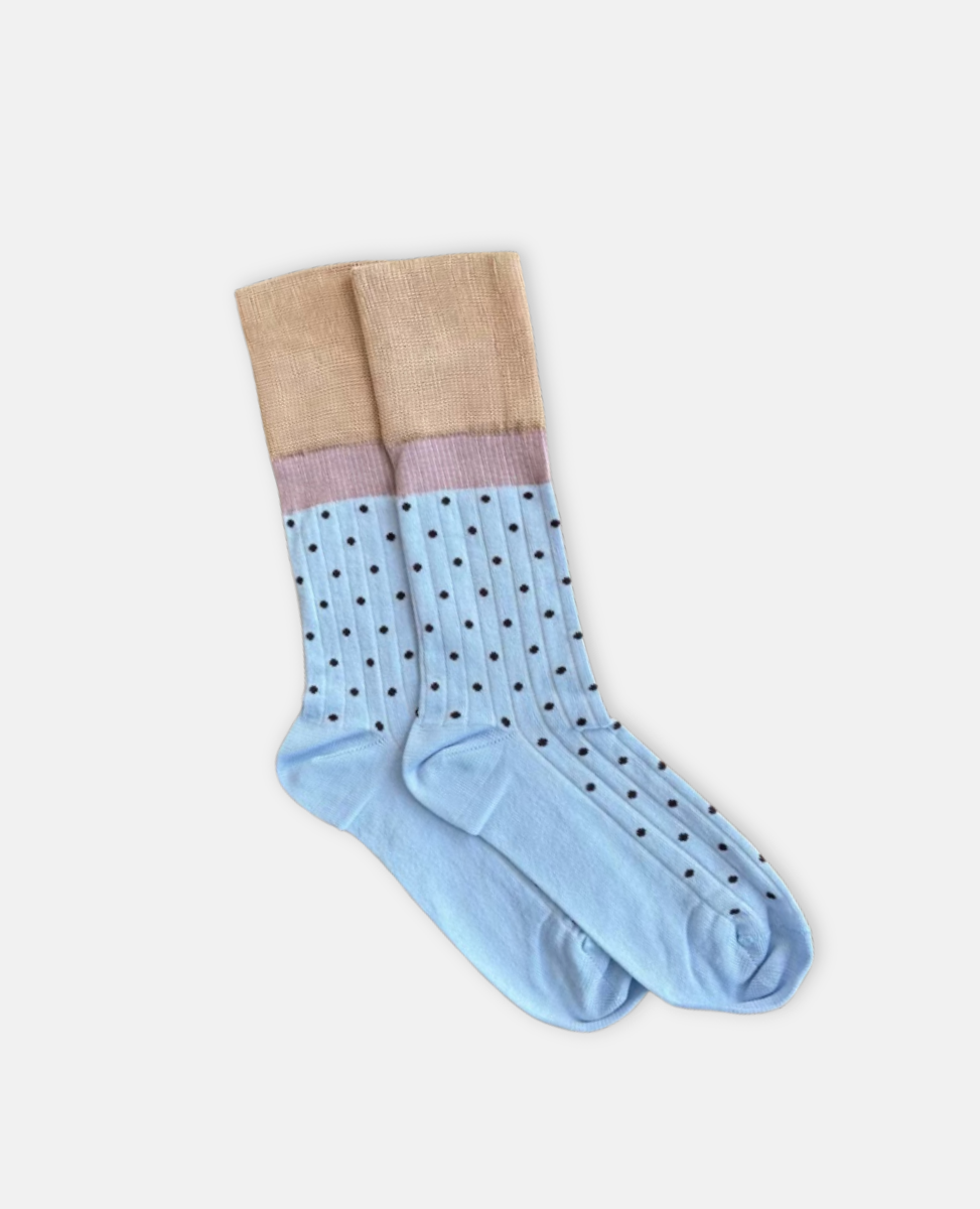 Pair of light blue socks with beige tops on a white background