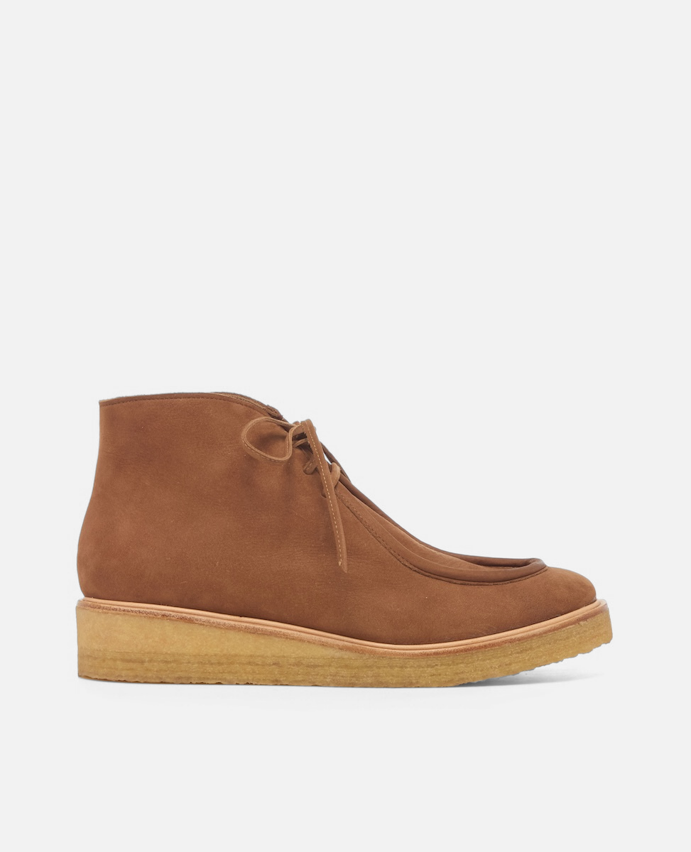 Brown suede ankle boot on a light gray background