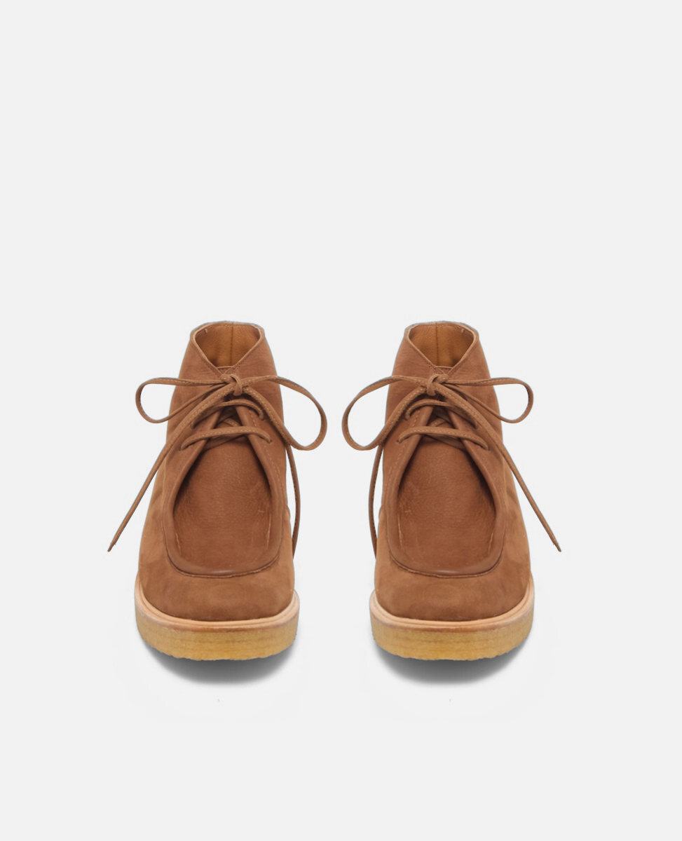 Pair of brown suede boots on a white background
