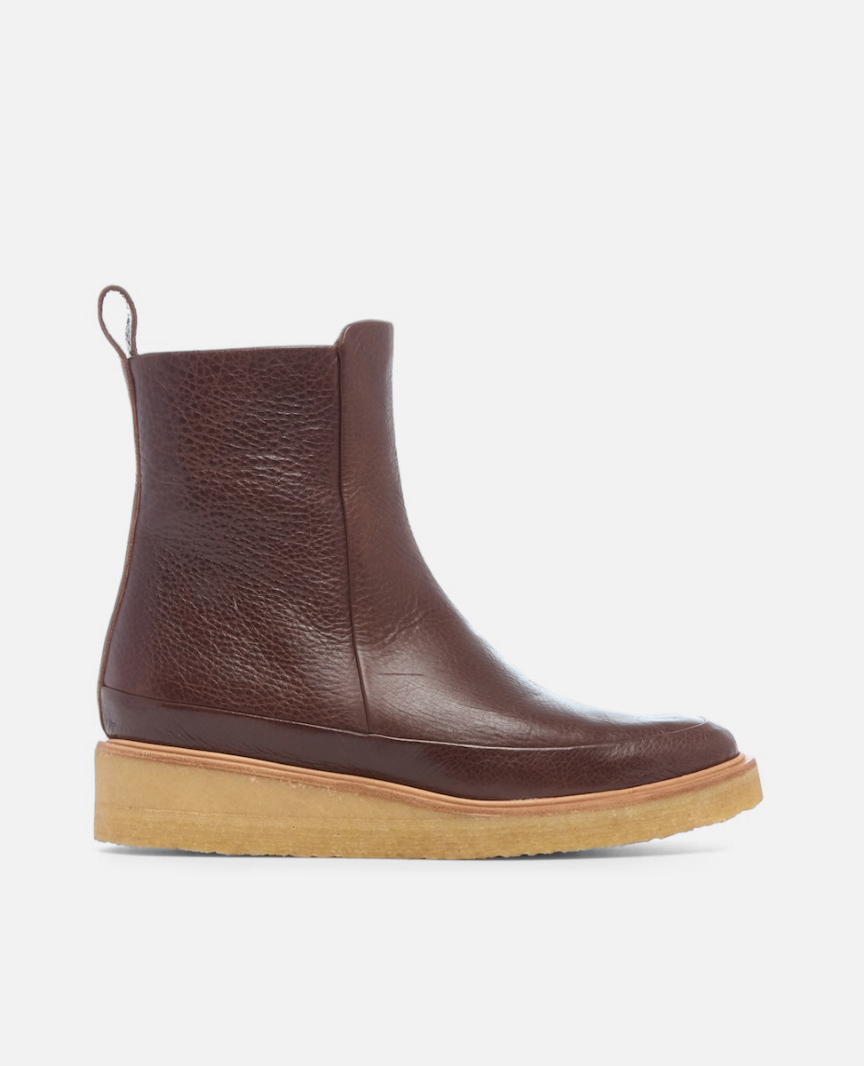 Brown leather ankle boot with a light brown sole on a white background