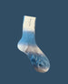 A single sock with a realistic print of a human face, featuring a blue and beige color gradient, made from a smooth, stretchy fabric with a standard crew length and a rectangular label attached at the top. 3