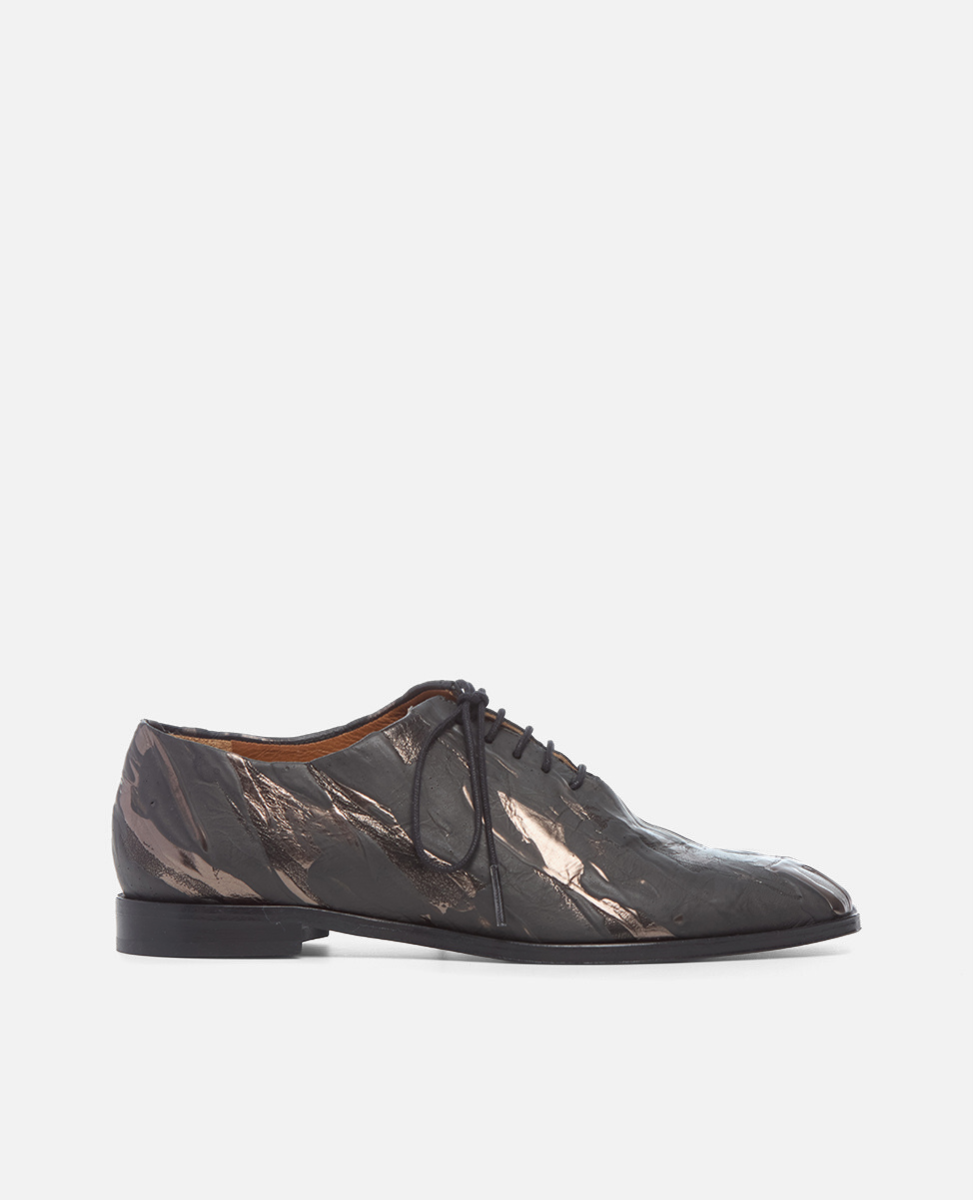Dark brown  painted leather shoe with a leather sole on a light gray background