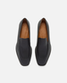 Pair of black loafers with tan interior on a white background 1