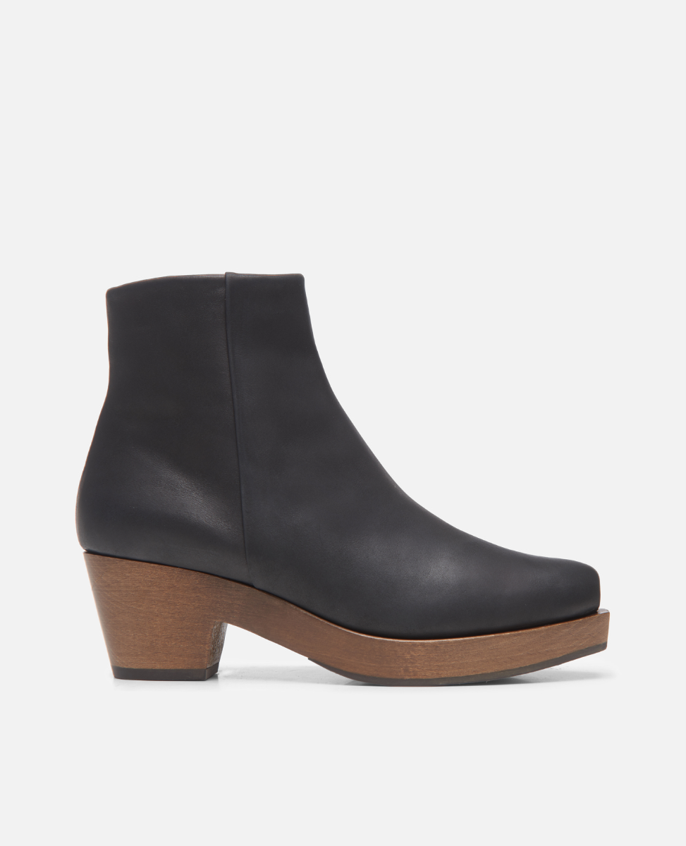 Black ankle boot with wooden heel on a white background