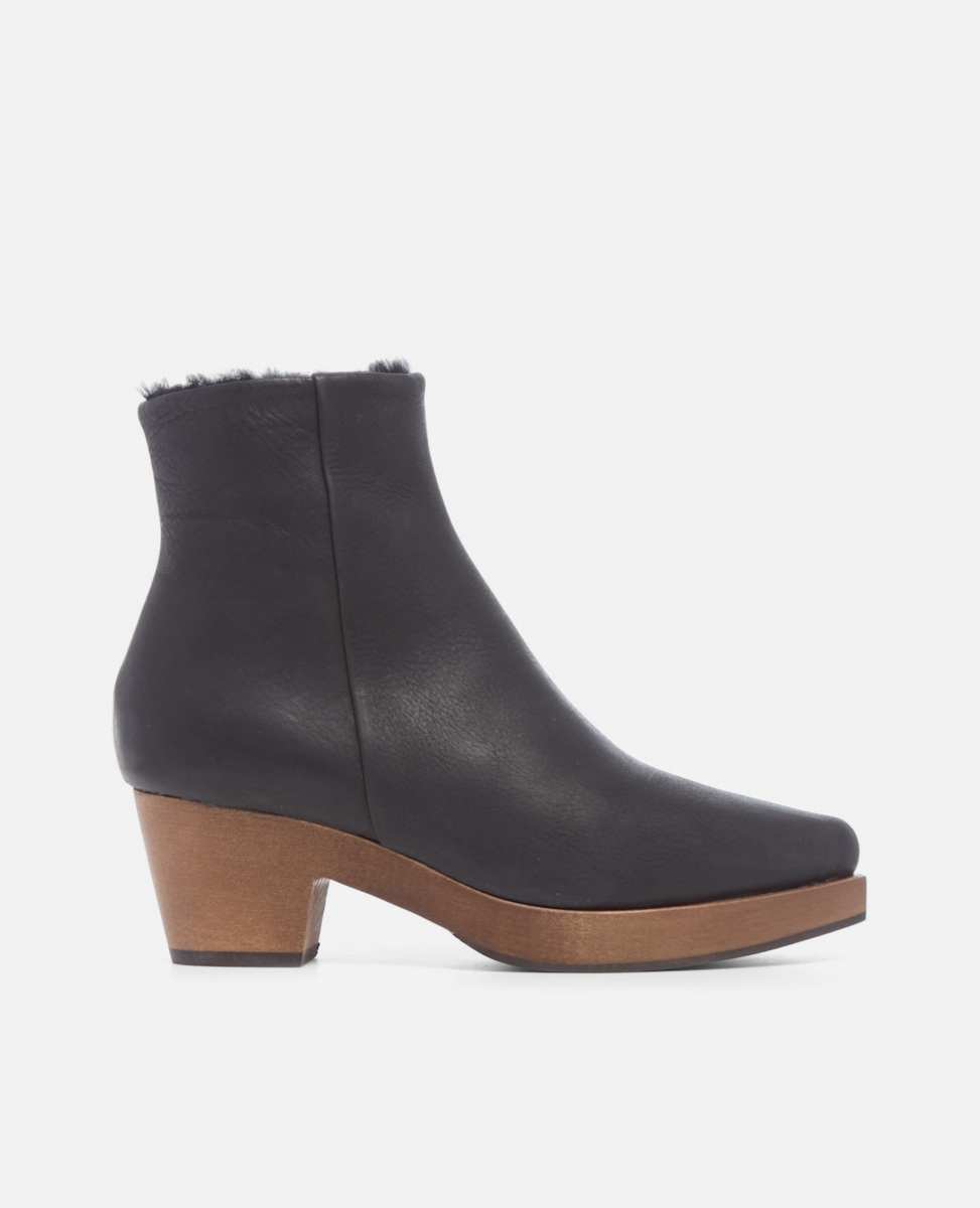 Black ankle boot with wooden heel on a white background