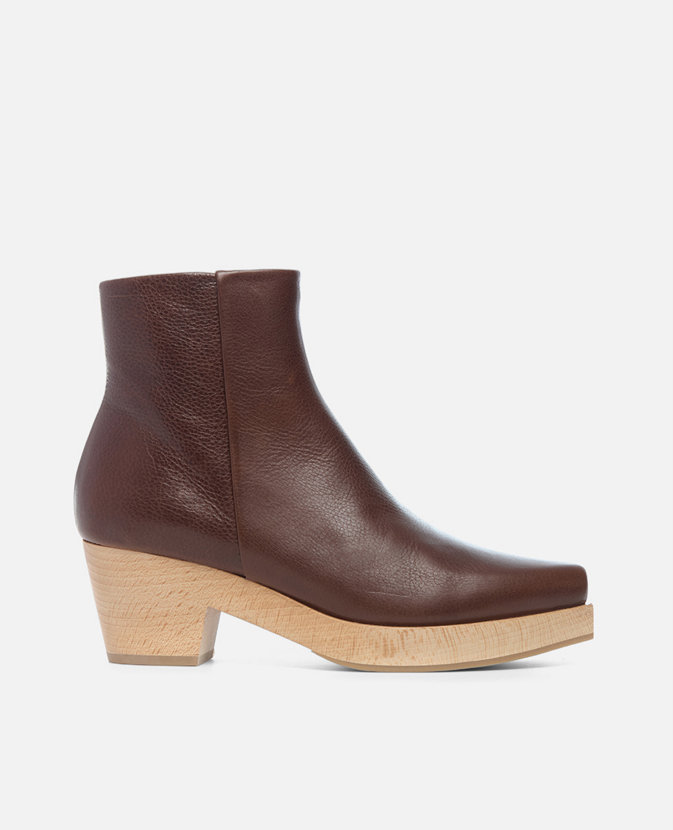Brown leather ankle boot with a wooden sole on a white background