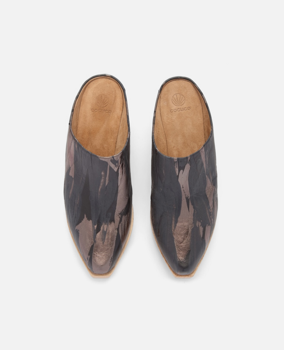 Pair of black and brown patterned shoes on a light gray background