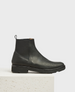 A sleek, black leather chelsea boot with a smooth texture, elastic side panels, a pull tab at the back, a square toe, and a sturdy treaded sole. 1