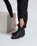 Black leather ankle boots with a smooth texture, lace-up design, and a sturdy, flat sole. 4