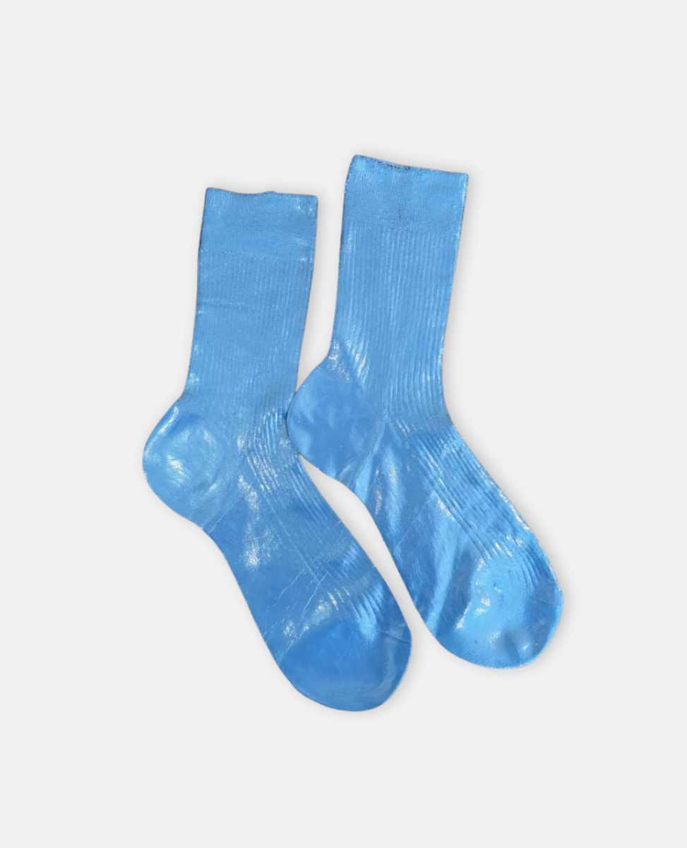 Pair of metallic foil royal blue silk socks by Maria La Rosa on a light gray background