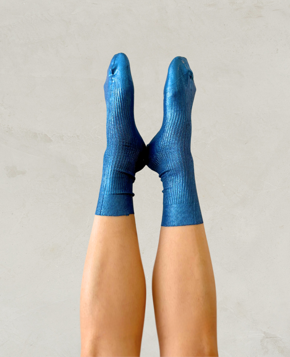 Pair of metallic foil royal blue silk socks by Maria La Rosa shown on the foot