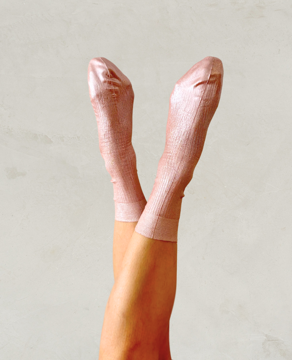 Pair of metallic foil pale pink silk socks by Maria La Rosa shown on the foot