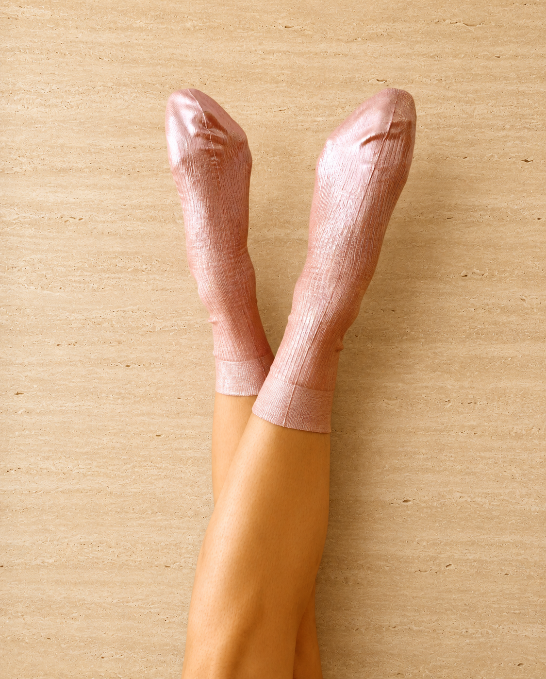 Pair of metallic foil pale pink silk socks by Maria La Rosa shown on the foot