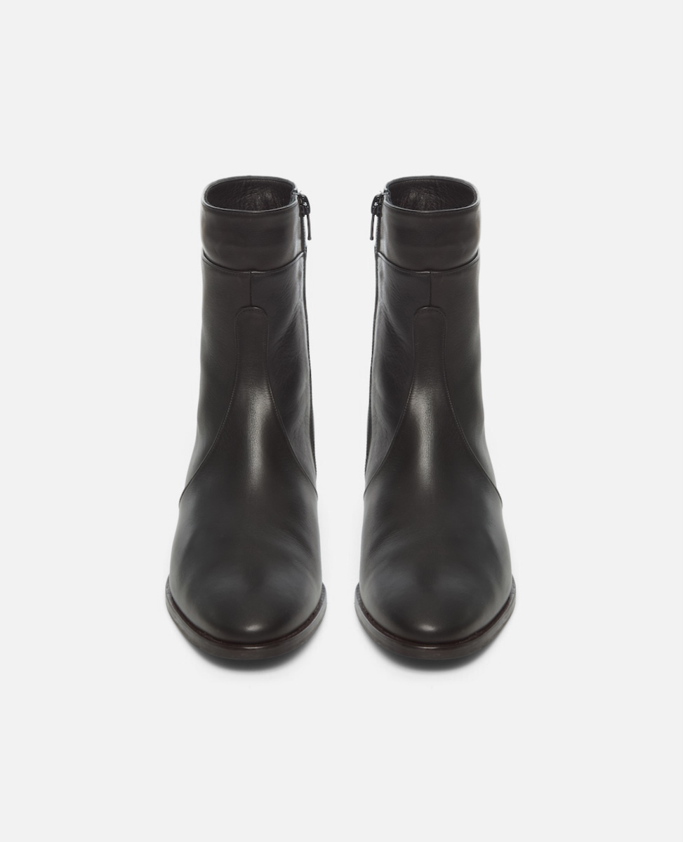 Pair of black leather ankle boots on a white background