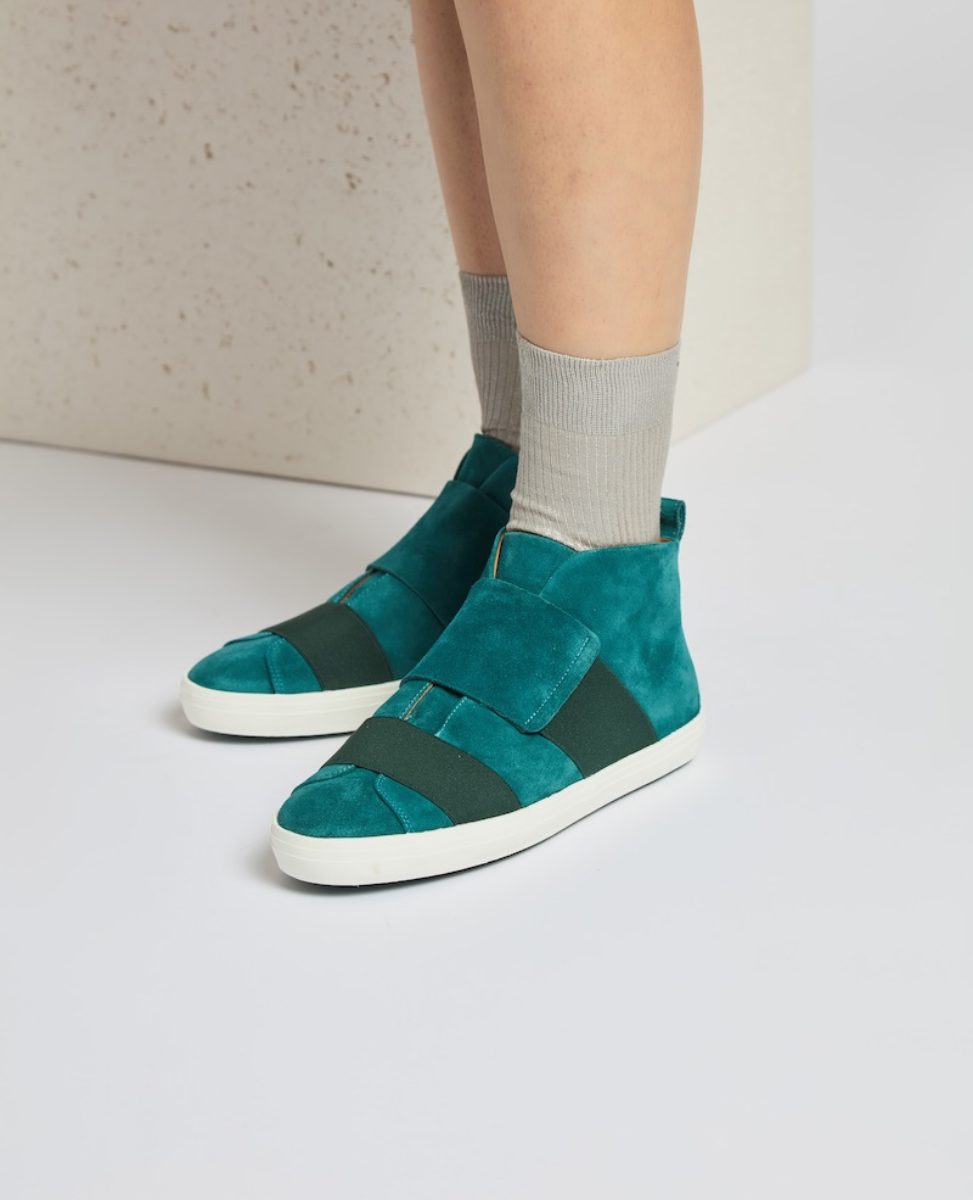 Teal suede high-top sneakers with white rubber soles, featuring wide black elastic bands across the top and a minimalist design.