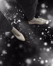 GIF of model wearing silver socks and white shohes, silver star dust effect in the background 3