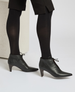 Sleek black ankle boots with a pointed toe, mid-height cone heel, lace-up front, and smooth leather finish. 6