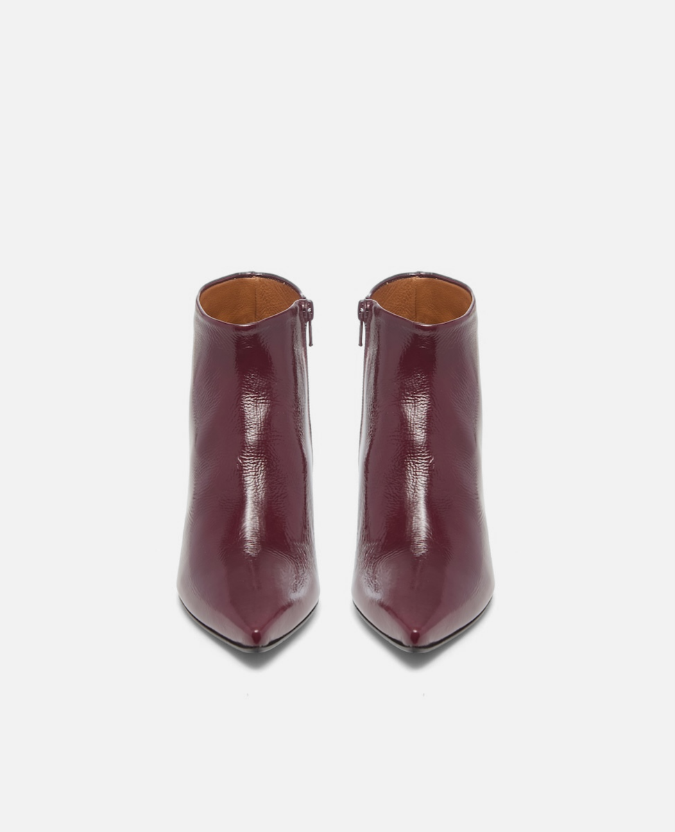 Pair of burgundy ankle boots on a white background