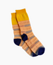 A pair of mid-calf socks featuring a vibrant design with alternating bands of yellow, orange, and gray, complemented by dark blue heels and toes, crafted from a soft, knitted fabric with a ribbed texture at the cuffs. 2