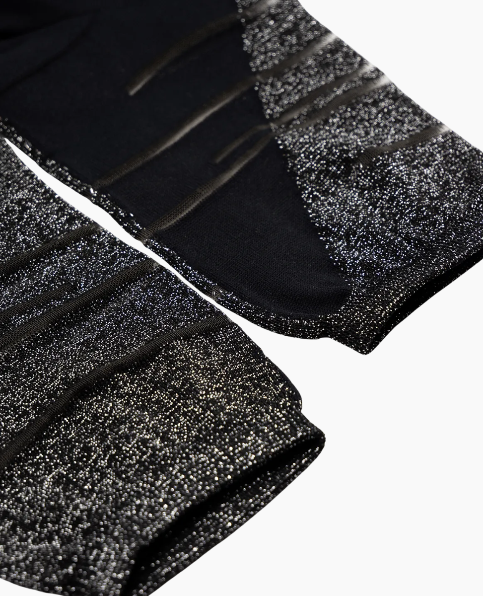 Black and silver glittery socks on a white background