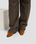 Brown pants and suede shoes on a light gray background 5
