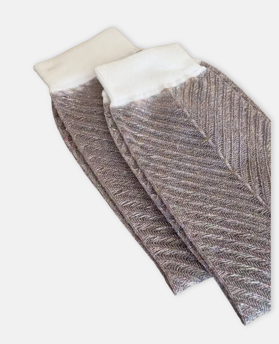 Pair of silver socks with white cuffs on a light gray background