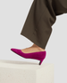 Purple high-heeled shoes worn with brown pants on a light background 5