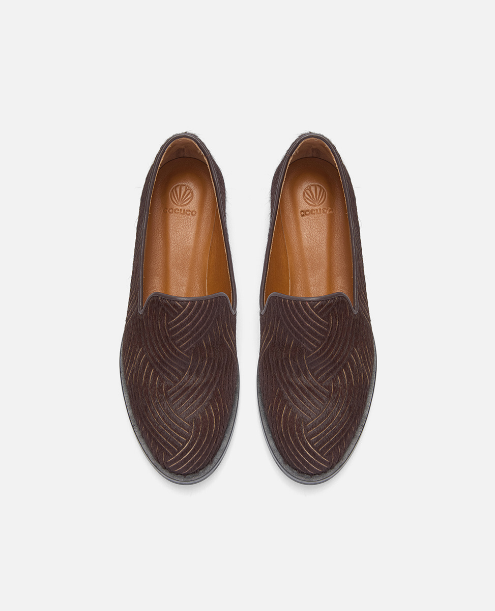 Pair of brown loafers with a subtle pattern on a white background