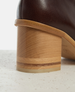 Close-up of a brown leather boot with wooden sole on a light background 6