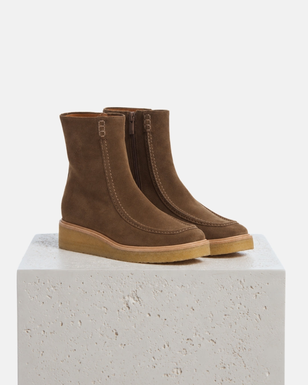 Coclico Haber Boot in brown suede moc toe boots with crepe wedge soles styled on a stone plinth