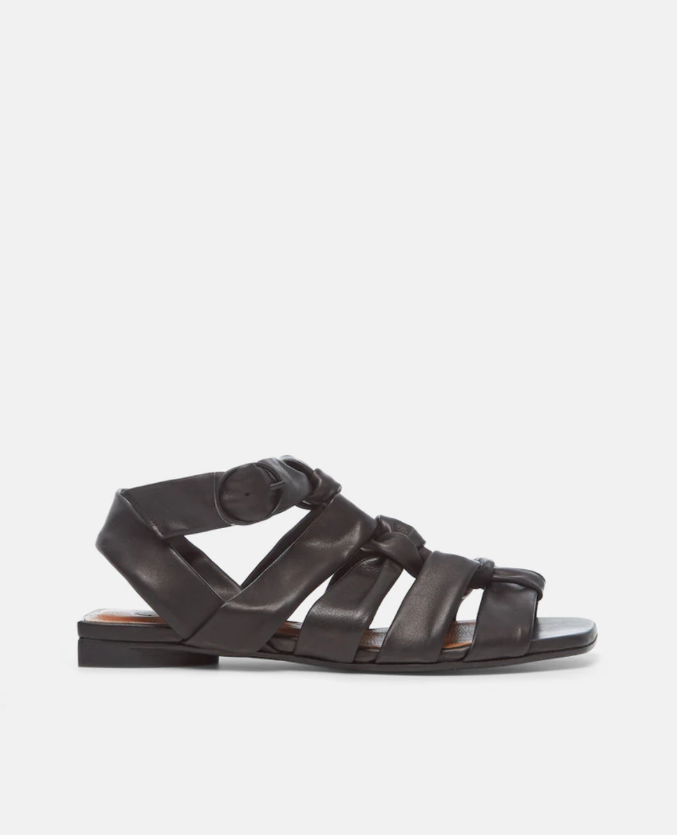 Side view of the Flair Gladiator Sandal in Black featuring the softest, tubular leather straps that twist upward and are secured at the ankle by a buckle fastening.