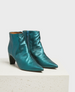 A pair of metallic teal ankle boots with pointed toes, a side zipper, a smooth leather texture, and a medium block heel. 1