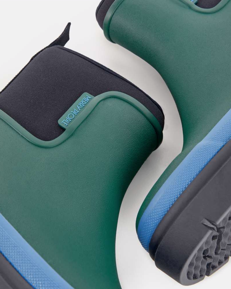 Close-up of the navy neoprene cuff, green rubber upper and Merry People logo tab