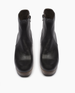Front view of the Tecla Clog in Black; featuring clean lines, snug fit, and curved solid wood platform heel make this clog boot a timeless classic. Inside zipper closure.Italian veg-tanned leather upper with solid wood 3
