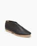 Coclico Arro Flat in Black leather, angle view: a slip-on flat with stretch leather that hugs foot, white two-part .5 inch EVA sole and a squared-off toe.  5