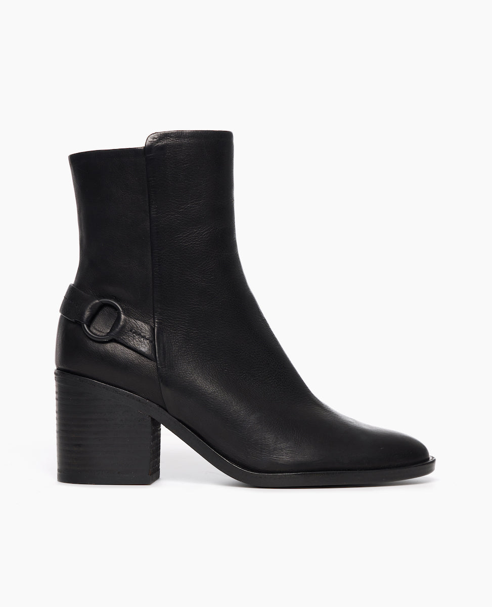 Side view of Coclico Babette Boot in Black leather: block-heeled, round-toe boot with half belt and loop detail adorn the heel.