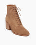 The Bani Boot in Tobacco suede: lace-up bootie featuring a natural stacked leather heel and inside sip. Angled view. 2