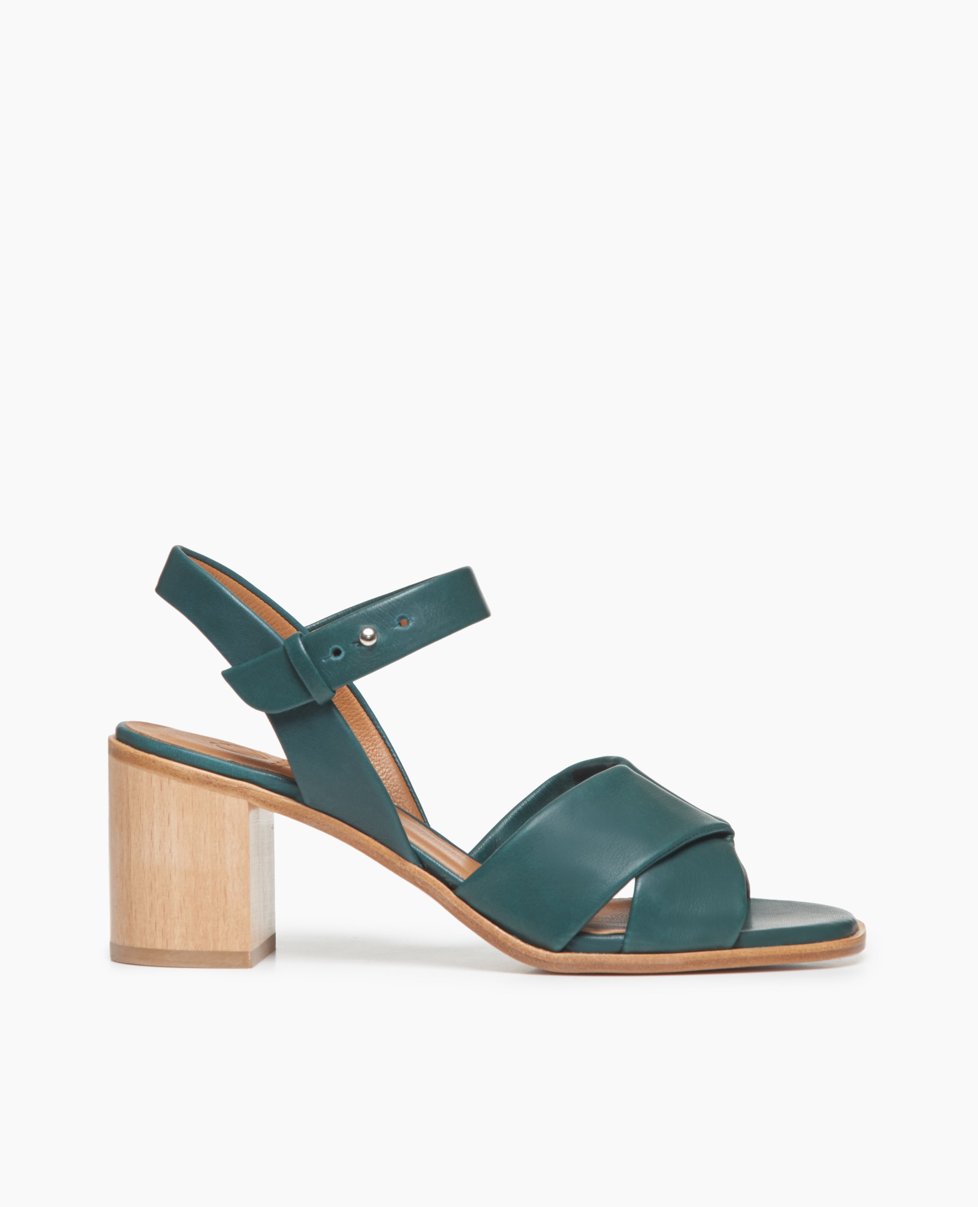 Side view of Coclico Bay Heel in Riviera leather: open sandal with 2 tubular straps across the foot, ankle strap, peg closure, wood block mid-height heel.