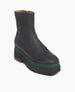 Angle view: Coclico Charme Boot in Black leather, with an inside zip closure, angular toe and a modest green platform that connects mid-height black water-resistant treated EVA soles to leather body  4