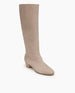 Coclico Chip Boot in Limestone nubuck, angle view : knee-high boot with an inside zip closure, elastic goring, seam detailing across arch and low-height solid wood block heel.   3