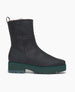 Side view of Coclico Chouchou Shearling Boot in Black leather: a lightweight shearling lining boot with green mid-height water-resistant treaded EVA soles.  1