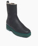 Coclico Chouchou Shearling Boot in Black leather, a lightweight shearling lining boot with green, mid-height, water-resistant treaded EVA soles - angle view.  2