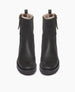 Durum Shearling Boot displayed from the front in black leather. This boot features an upper updated lug sole. It is an elevated moto boot featuring an outside zip closure and a full shearling-lined interior. 12