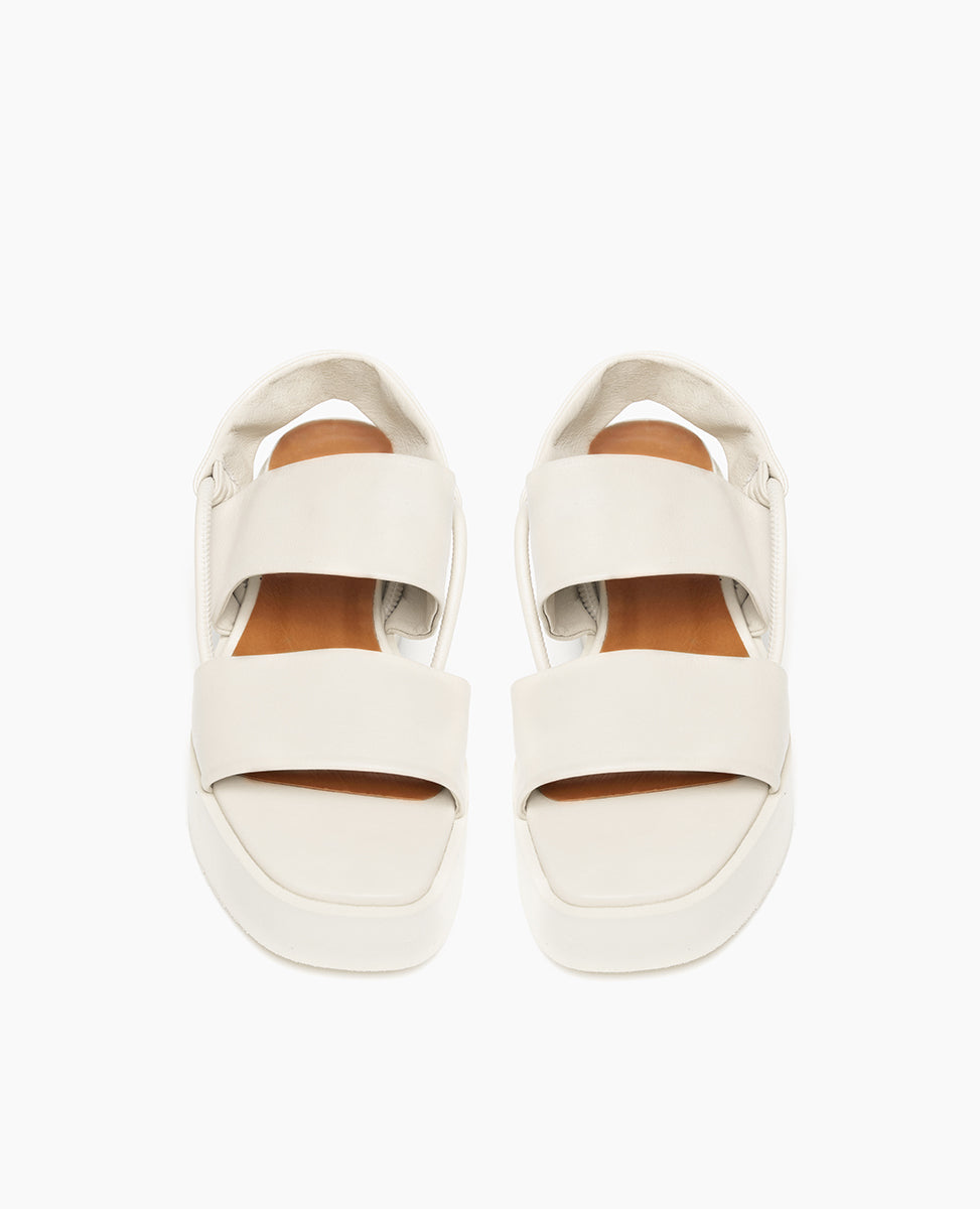 Top view: Coclico Imna Wedge in Greige leather: open wedge with 2 tubular straps across foot, mid-height EVA  flatform sole, elasticated slingback strap. 