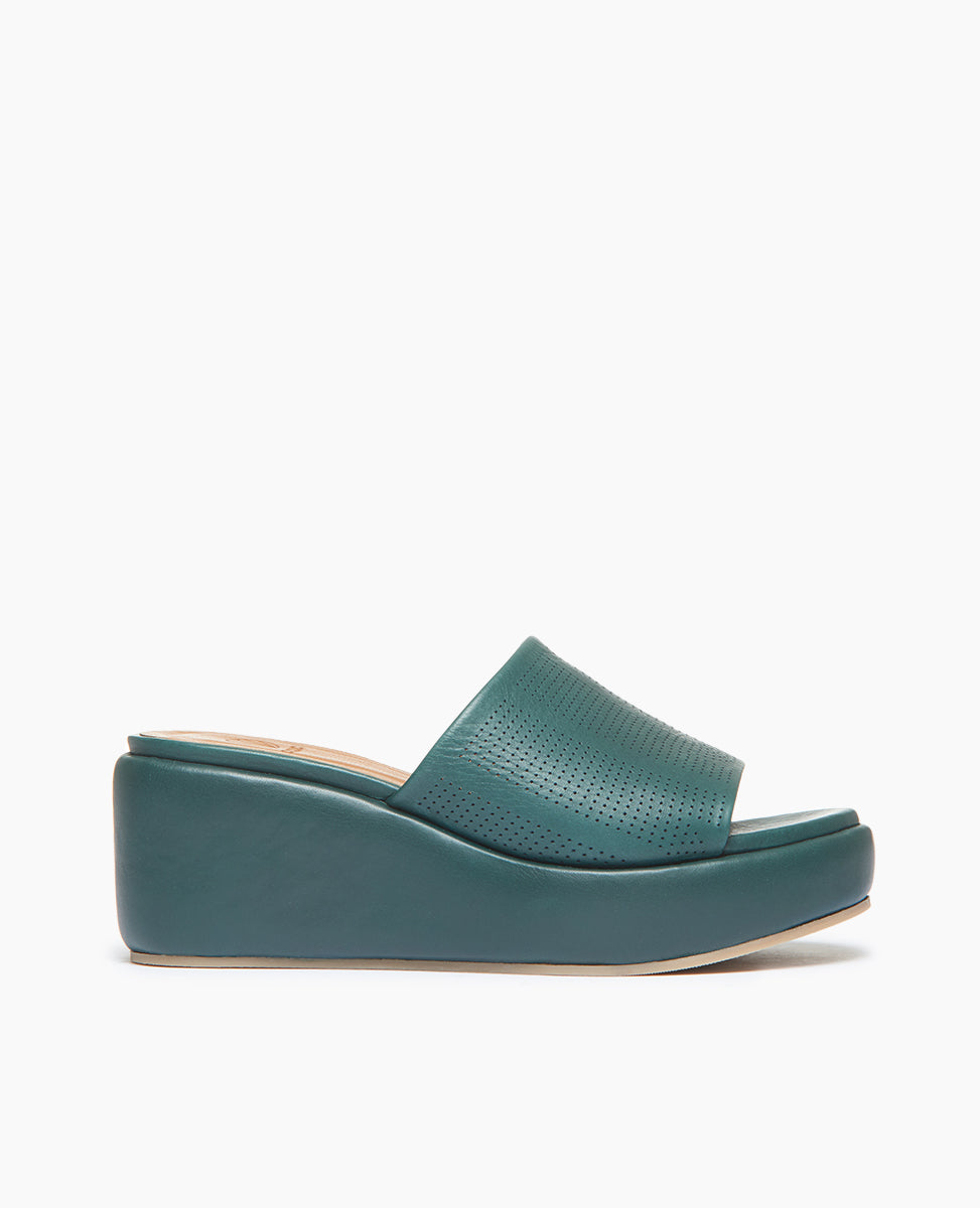 Side view of Coclico Laleh Wedge in Riviera Green leather perfed: slide-on cork wedge covered in padded leather with pinhole strap across foot. 