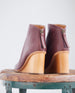 Close up of the sculpted 75mm solid wood wedge and back zip closure - Coclico Lovage Boot in Burgundy leather.  6